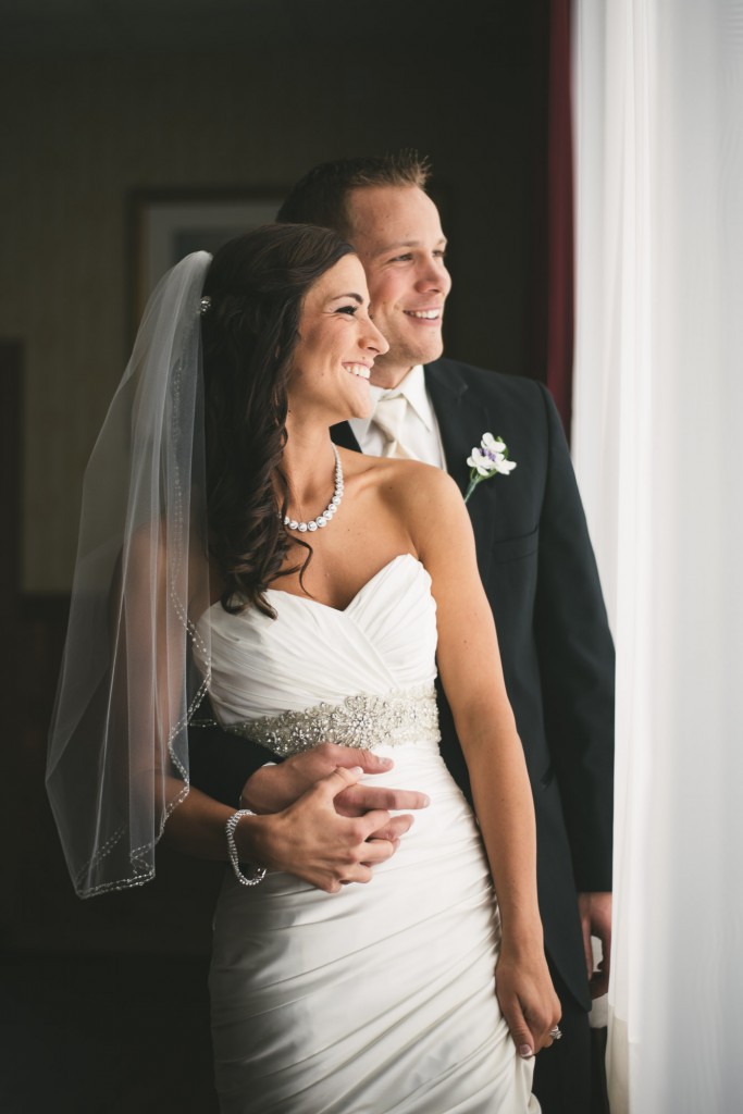 Bride and Groom looking out of a window with Tom Studios Wedding Photography 