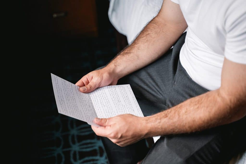 Hayloft on the Arch Wedding groom reading a letter