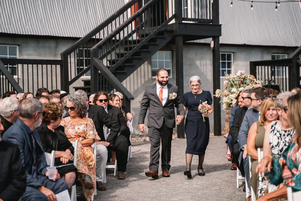 Hayloft on the Arch Wedding ceremony with groom walking down the aisle