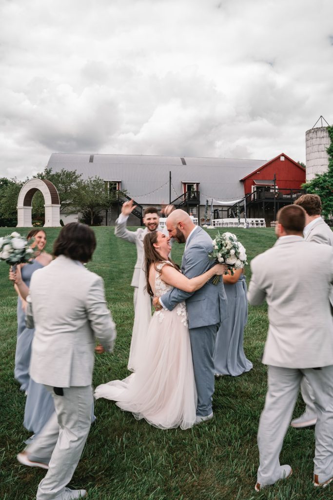 a bride and groom surrounded by their wedding crew for their upstate NY portrait