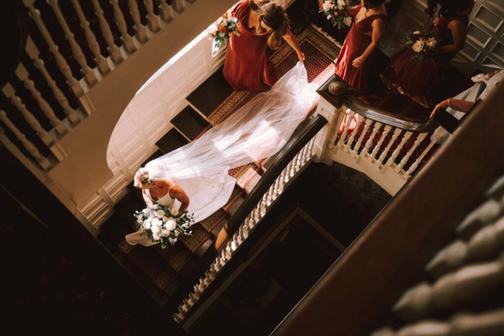 a bride and bridesmaids on a staircase