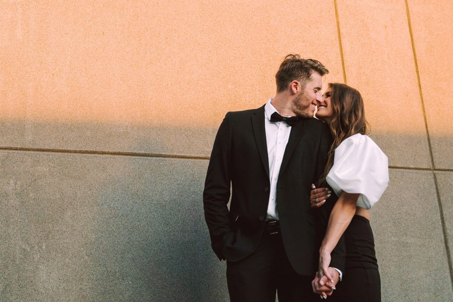 couple smiling at each other during their utica engagement session